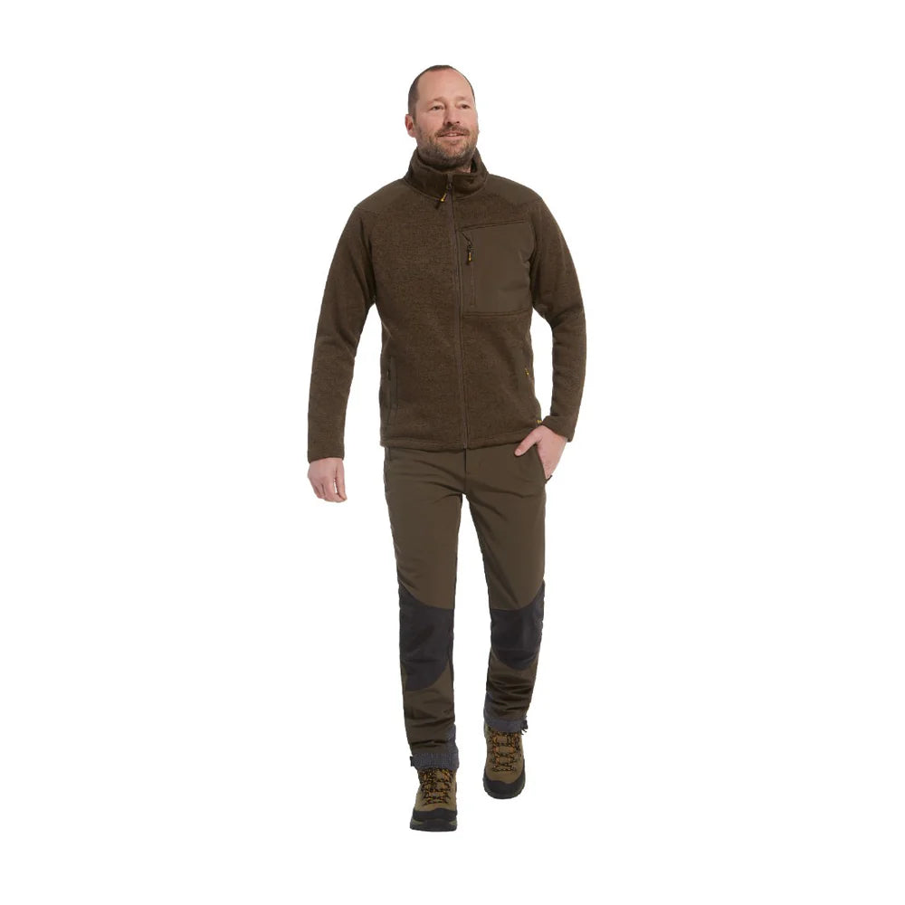 Modelo con chaqueta coarse verde oliva con pantalón verde oliva con refuerzos negros.