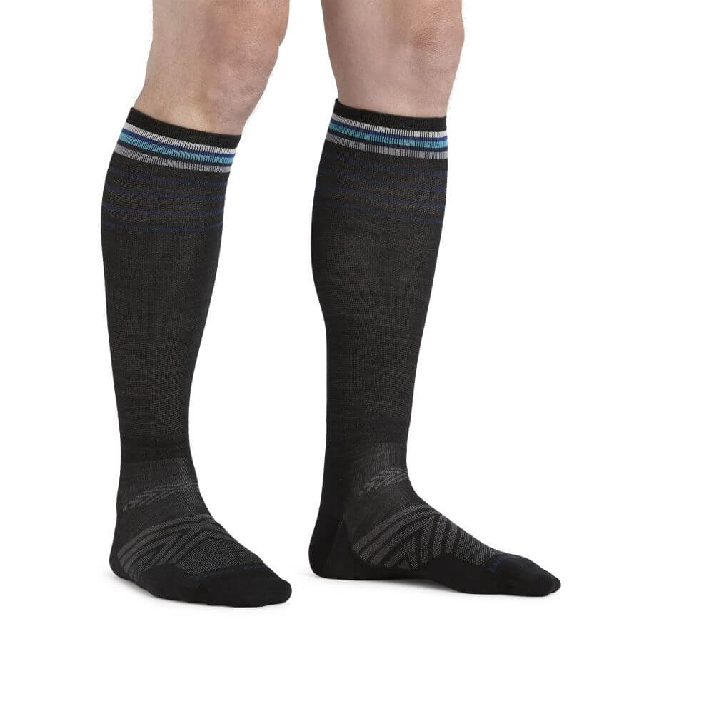 a woman wearing black shoes standing on a bench