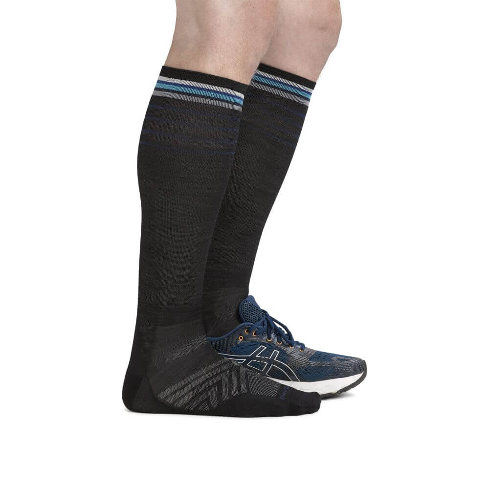 a man wearing a blue shirt and black shorts