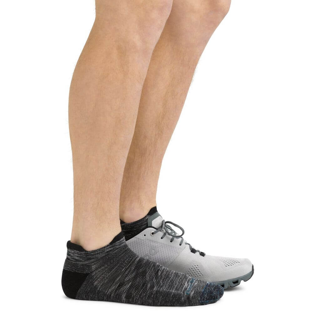 a man is wearing a pair of black shoes