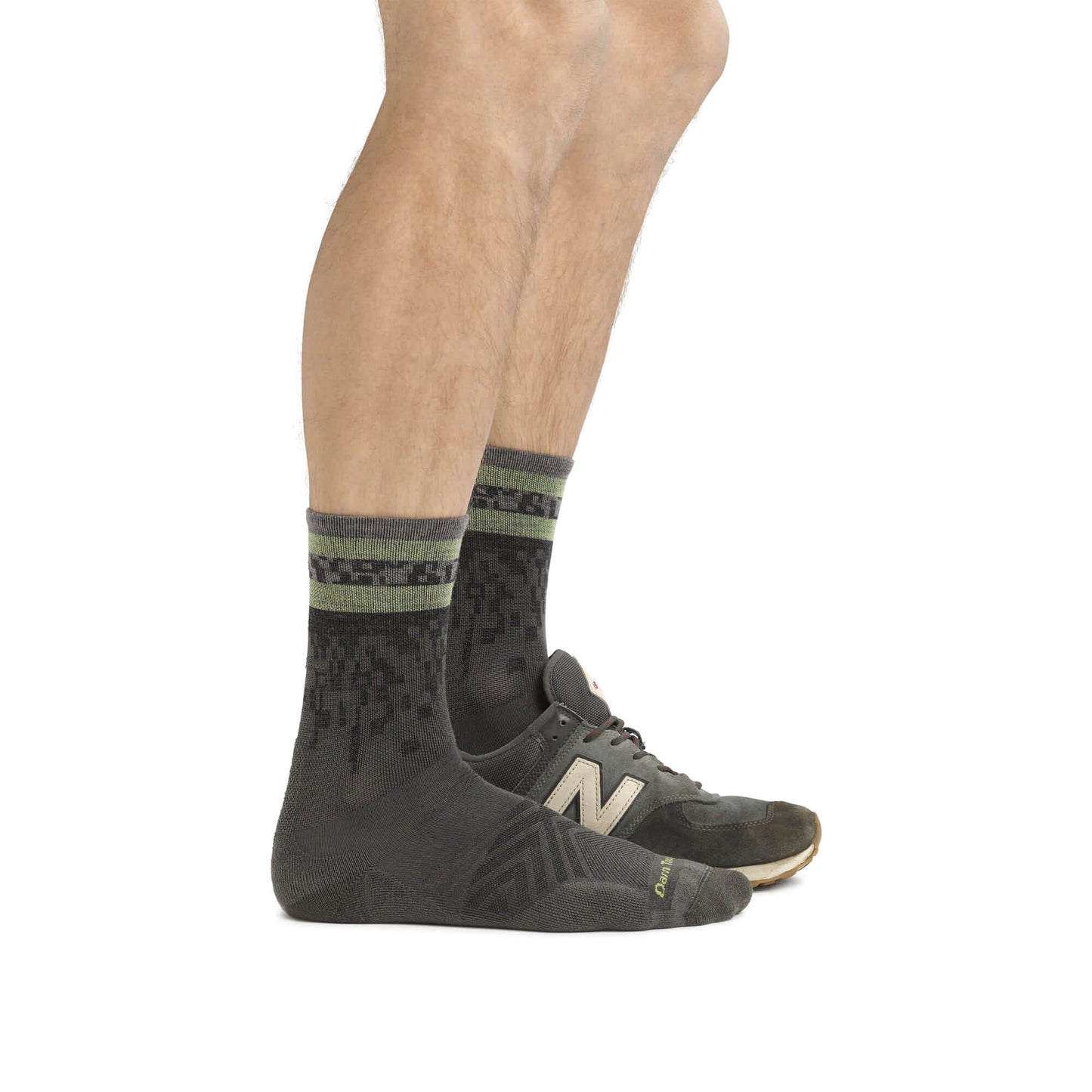 a person wearing a pair of black shoes