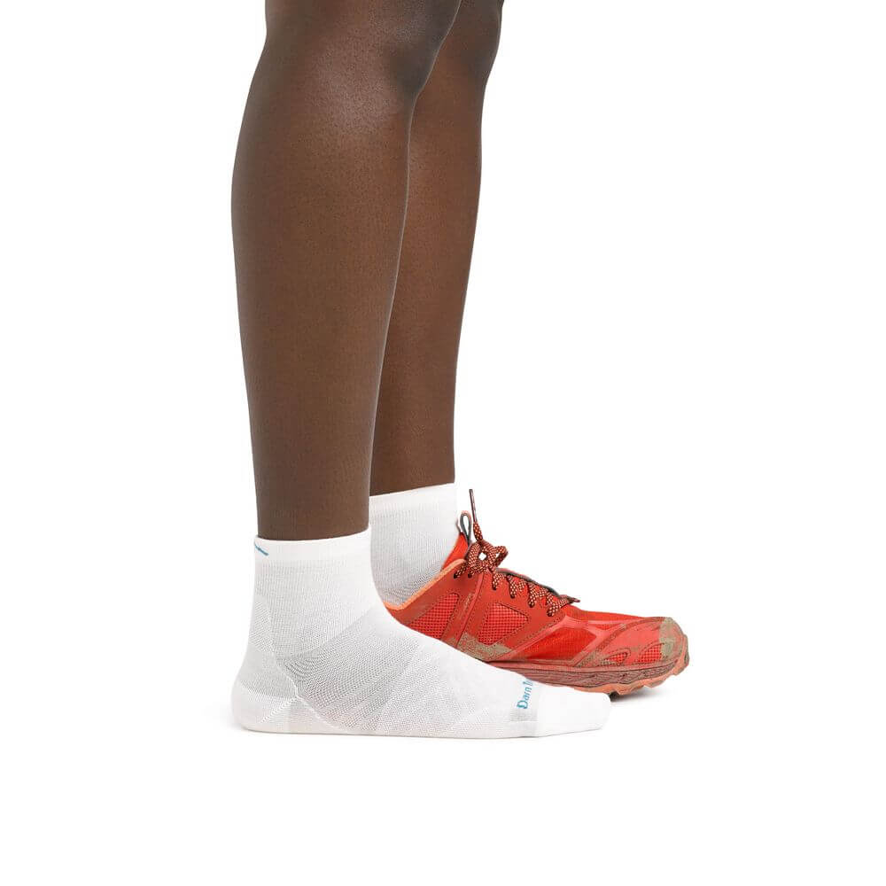 a close up of a person wearing red shoes