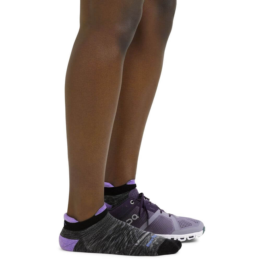 a person is standing on a skateboard on the ground