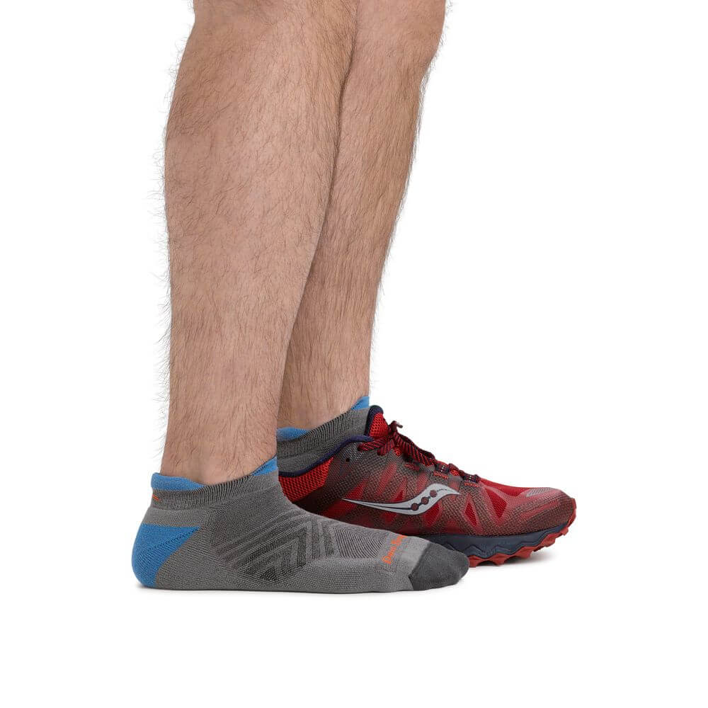 a man is wearing a pair of red sneakers