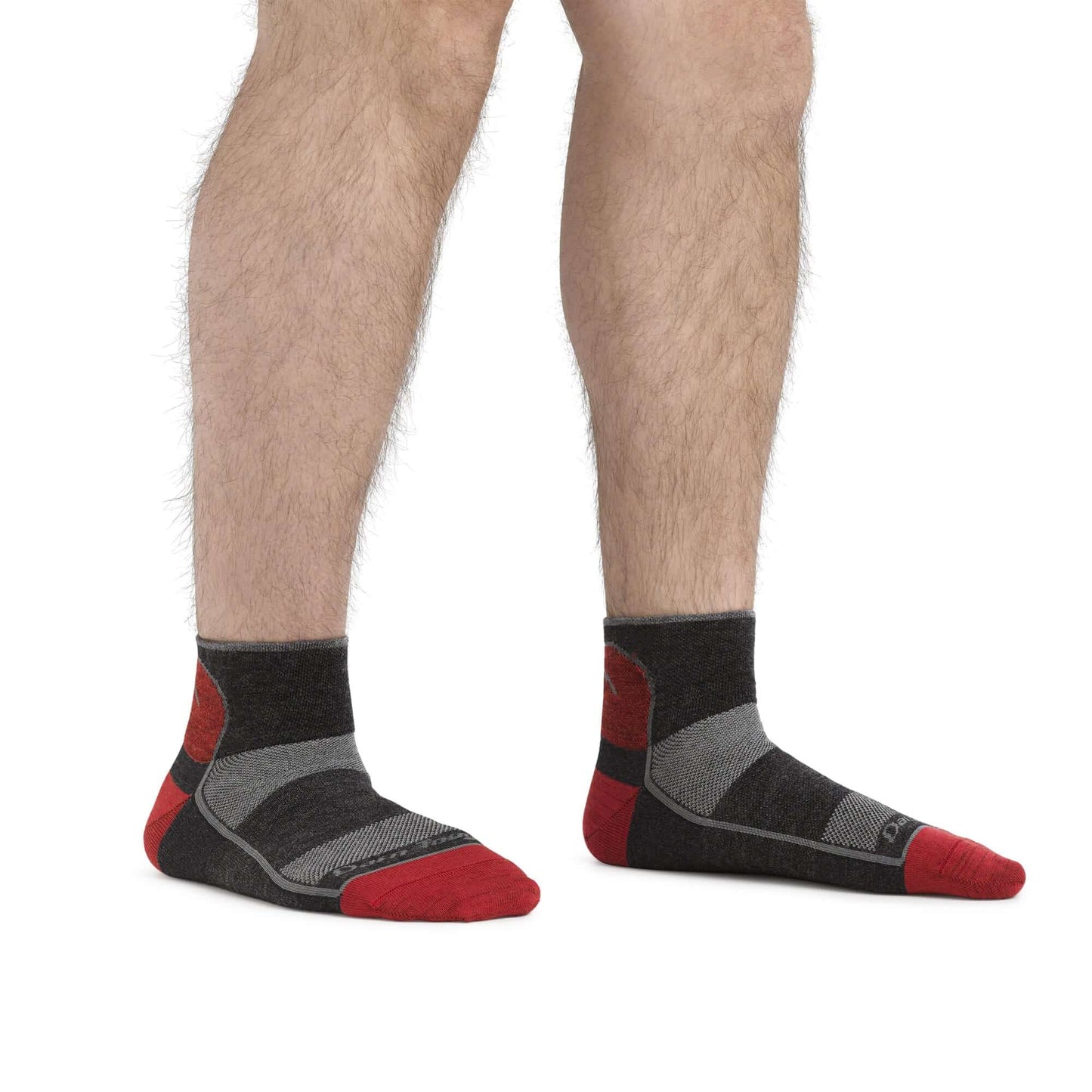 a person wearing black shoes standing on a bench