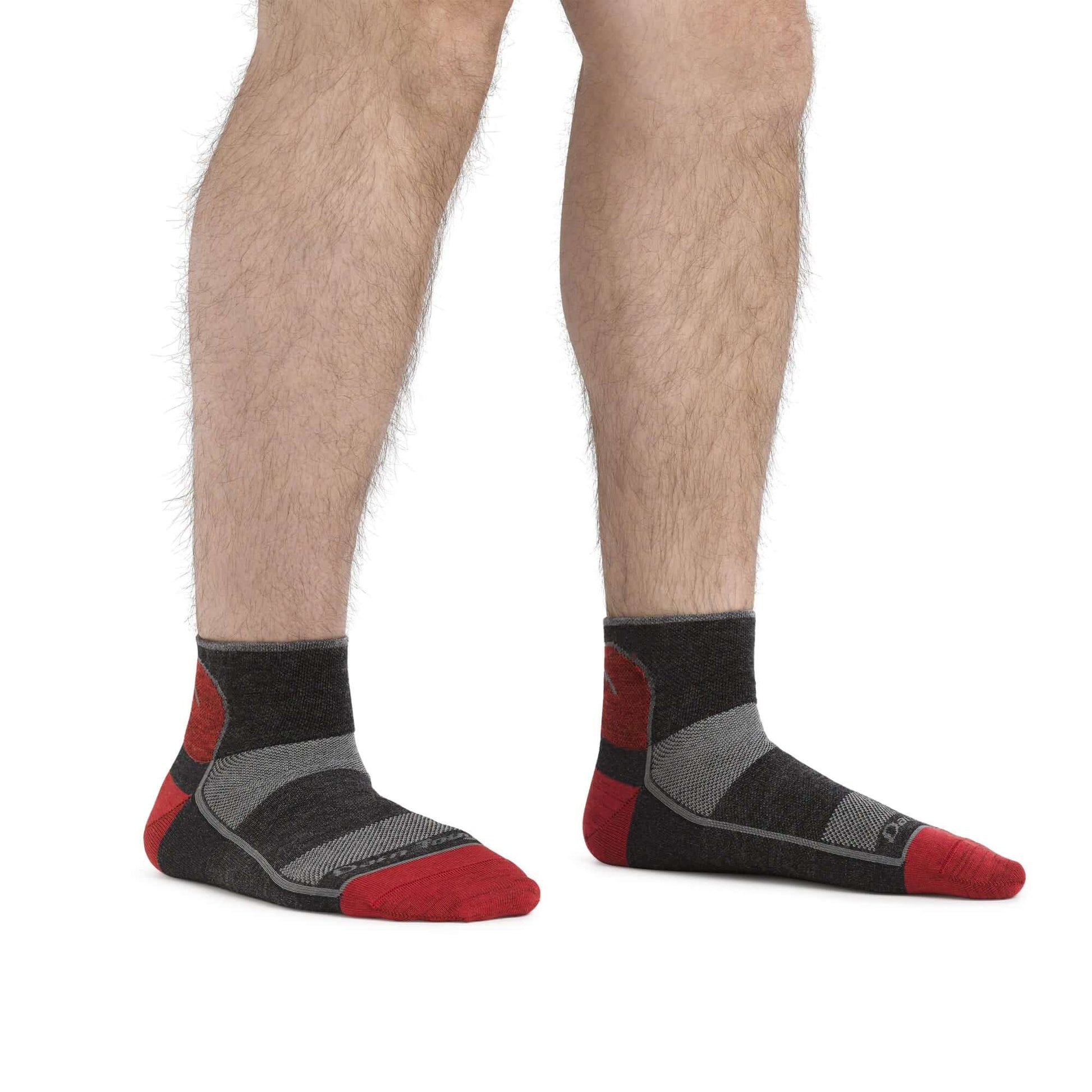 a person wearing black shoes standing on a bench