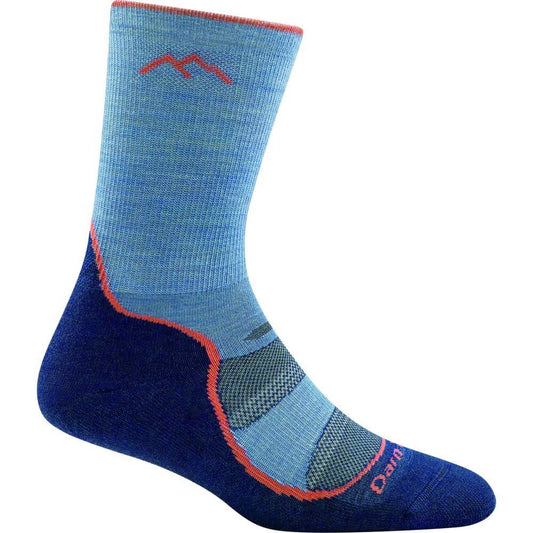 a persons feet with blue shoes and a skateboard