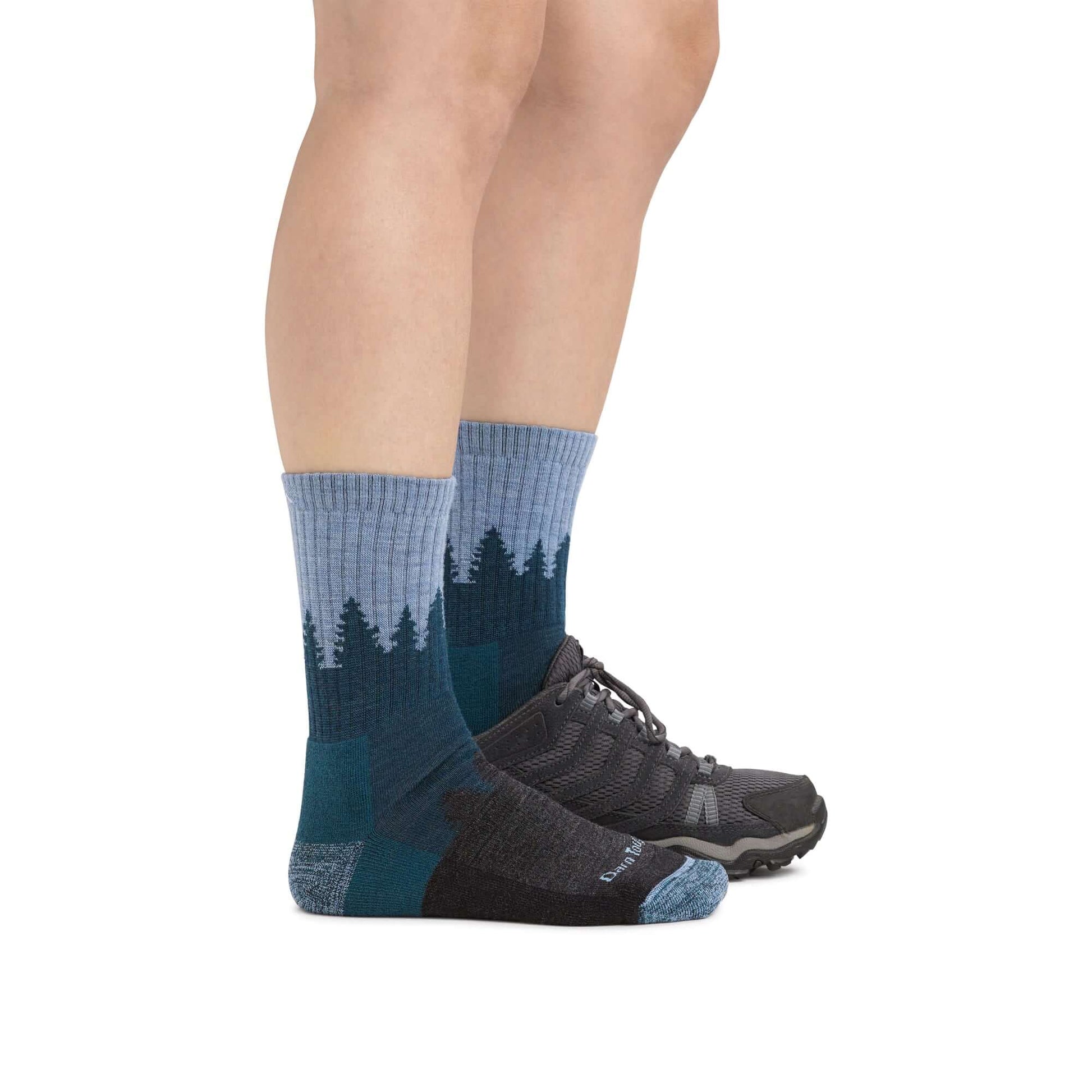 a person wearing a pair of black shoes