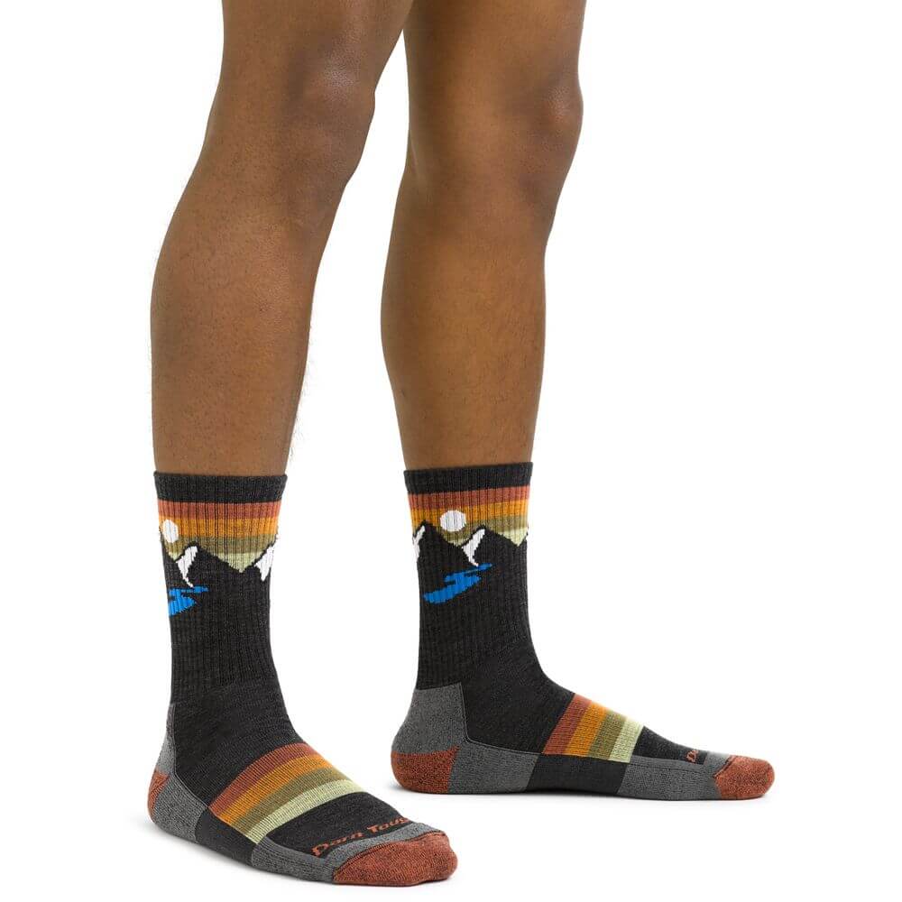 a pair of feet standing on top of a skateboard
