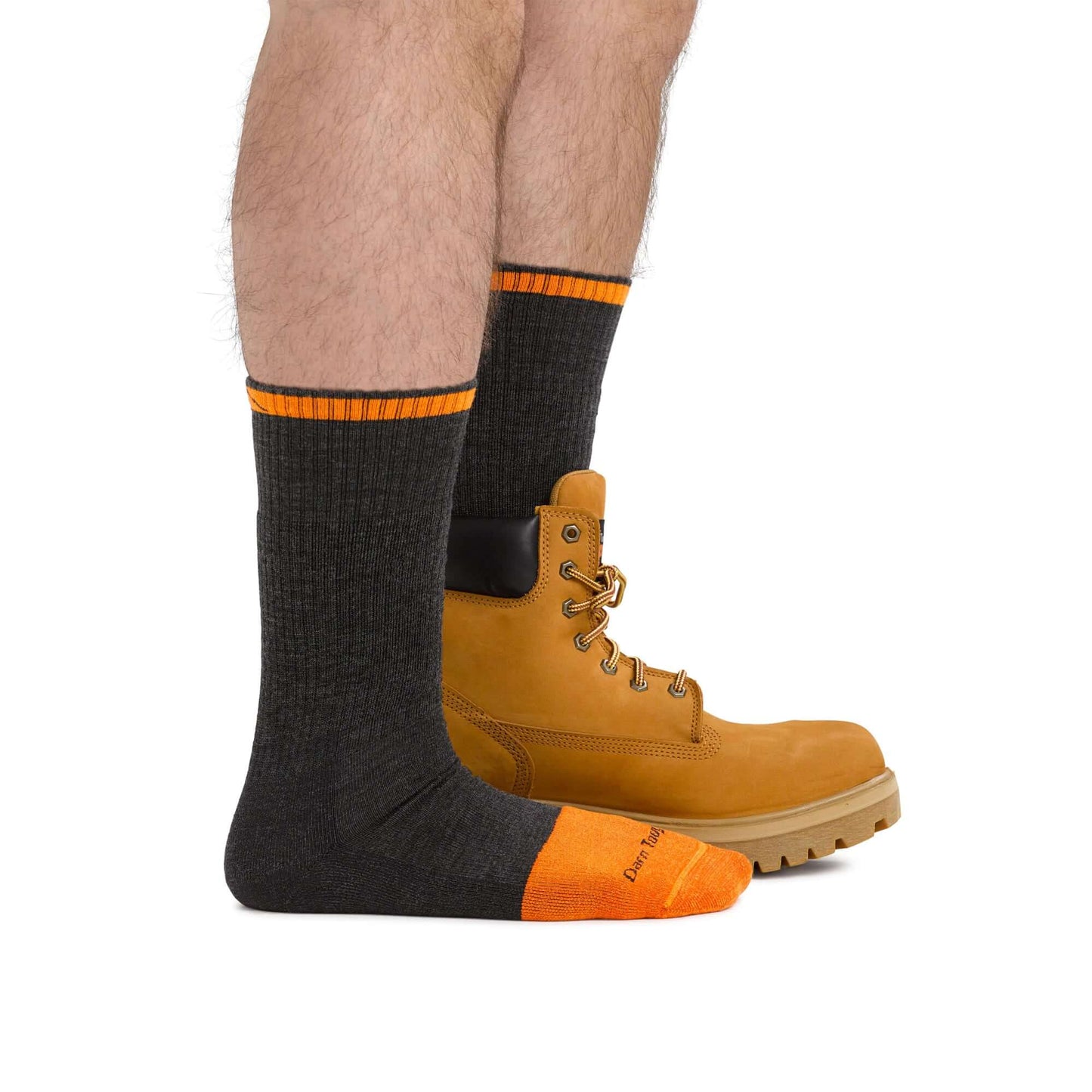 a person holding a pair of orange shoes